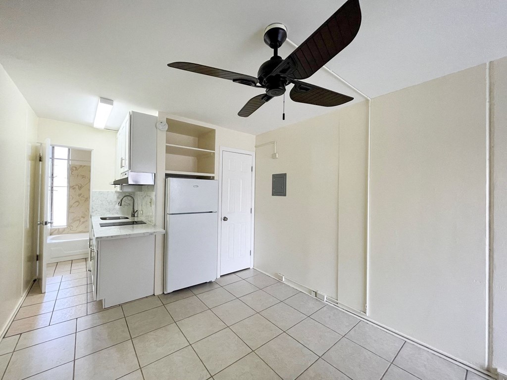a kitchen with a white refrigerator freezer next to a white cabinet