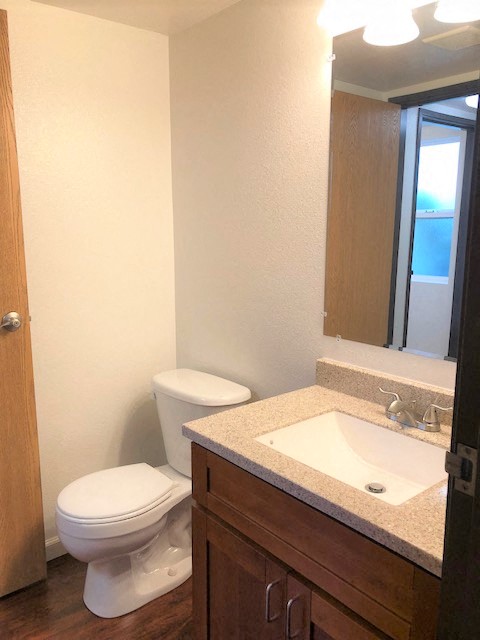 The Waterfront Apartments at Kahului bathroom sink, mirror, vanity, and toilet