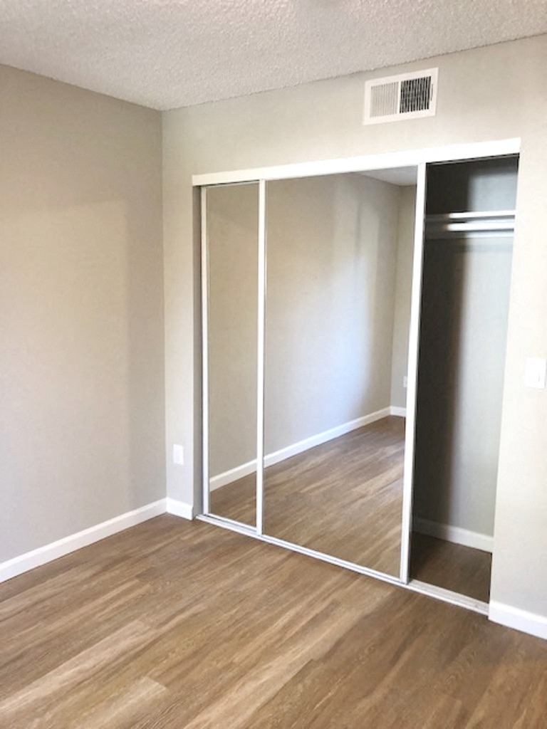 Monarch Terrace unfurnished bedroom with mirror closet