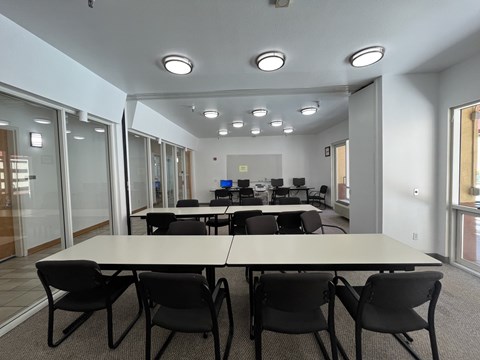 A conference room with a long table and chairs.