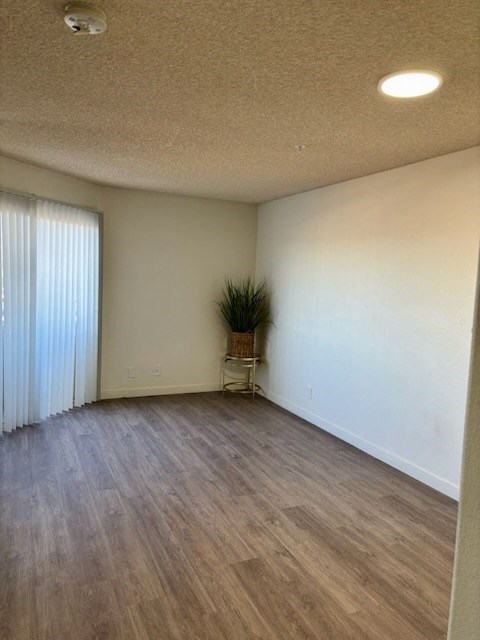 an empty living room with white walls and wood floors