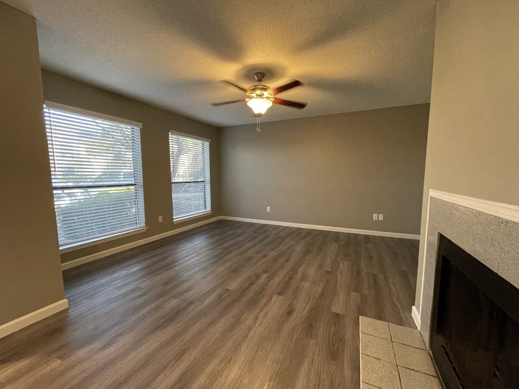 The Forest at Duck Creek Apartments Renovated Living Room with Fireplace and Large Windows