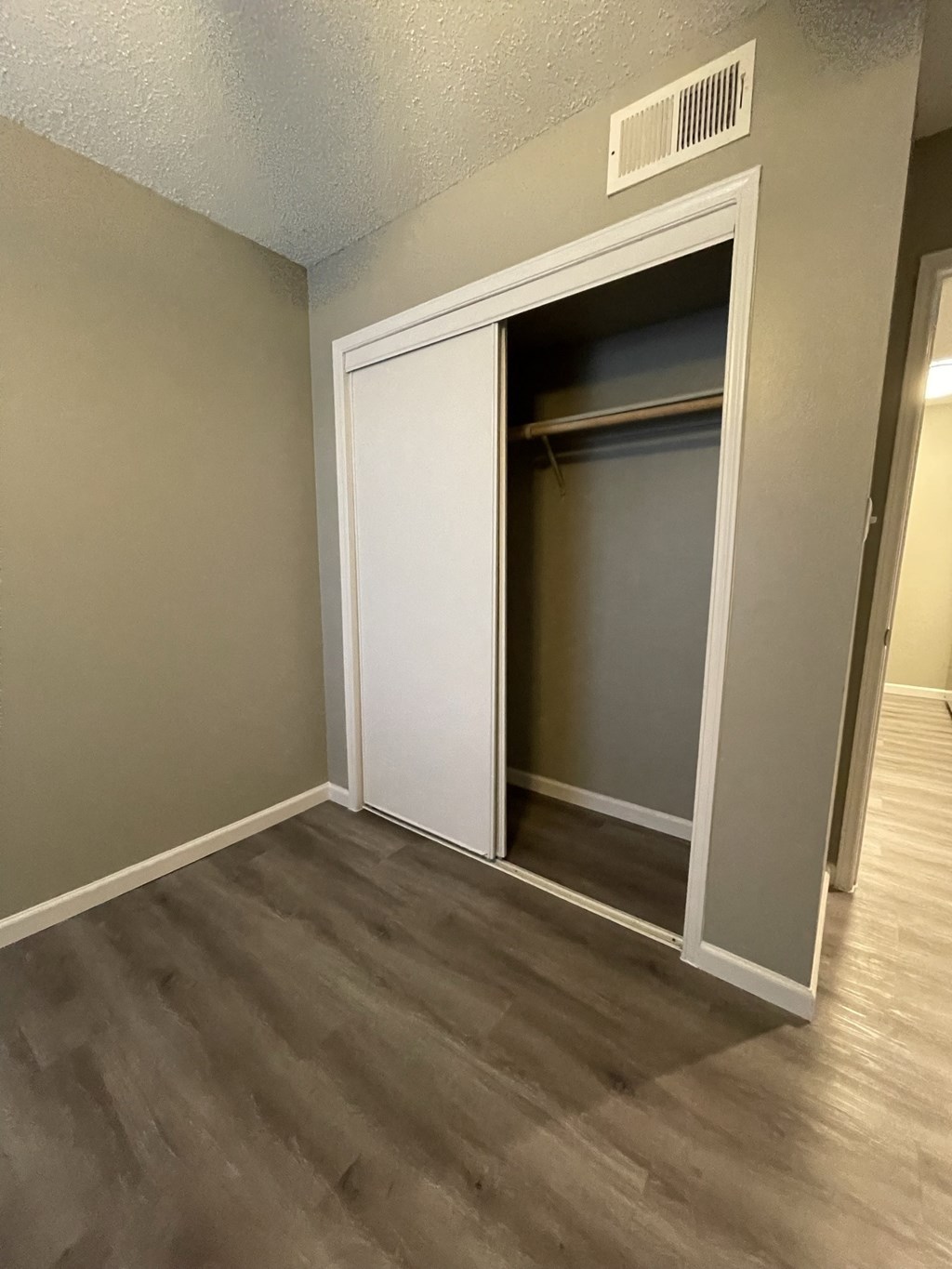 a bedroom with a closet and a door that is open