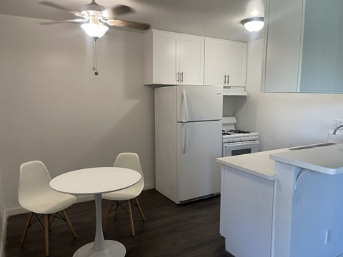 A small kitchen with a table and chairs.