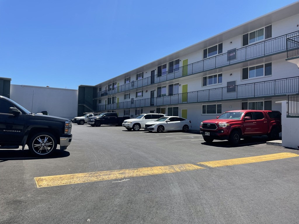 a parking lot with cars in front of a building
