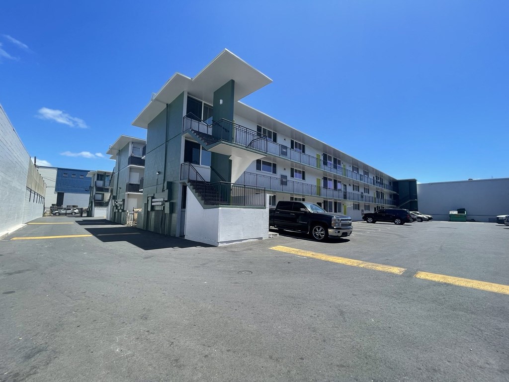 a building with a parking lot and a car in front of it