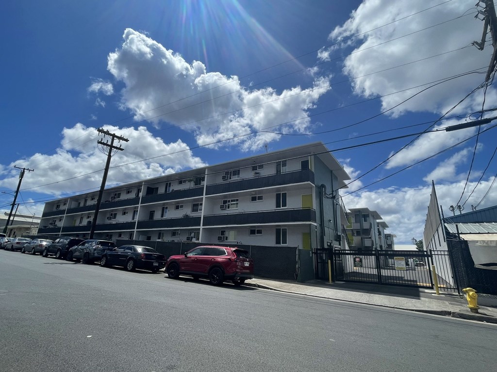a building on a city street with cars parked in front of it