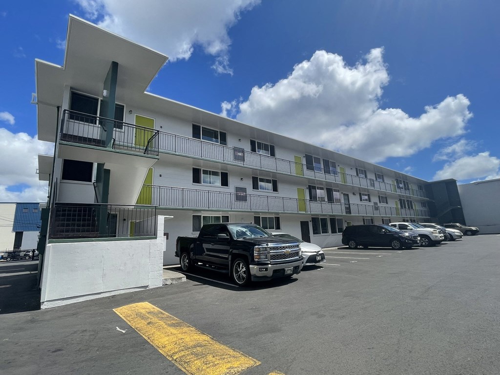 a large white building with cars parked in front of it