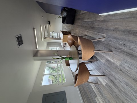 A modern room with a large window and a wooden floor.