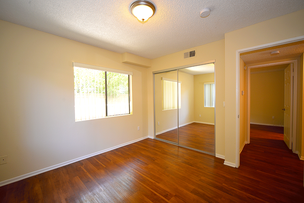 Monarch Terrace unfurnished bedroom with mirror closet