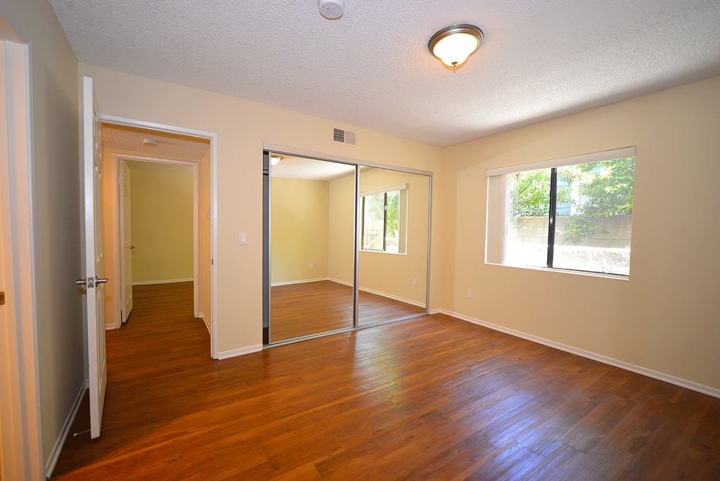 Monarch Terrace unfurnished bedroom with mirror closet