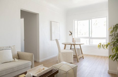 A living room with a couch, chair, and a table with a box on it.