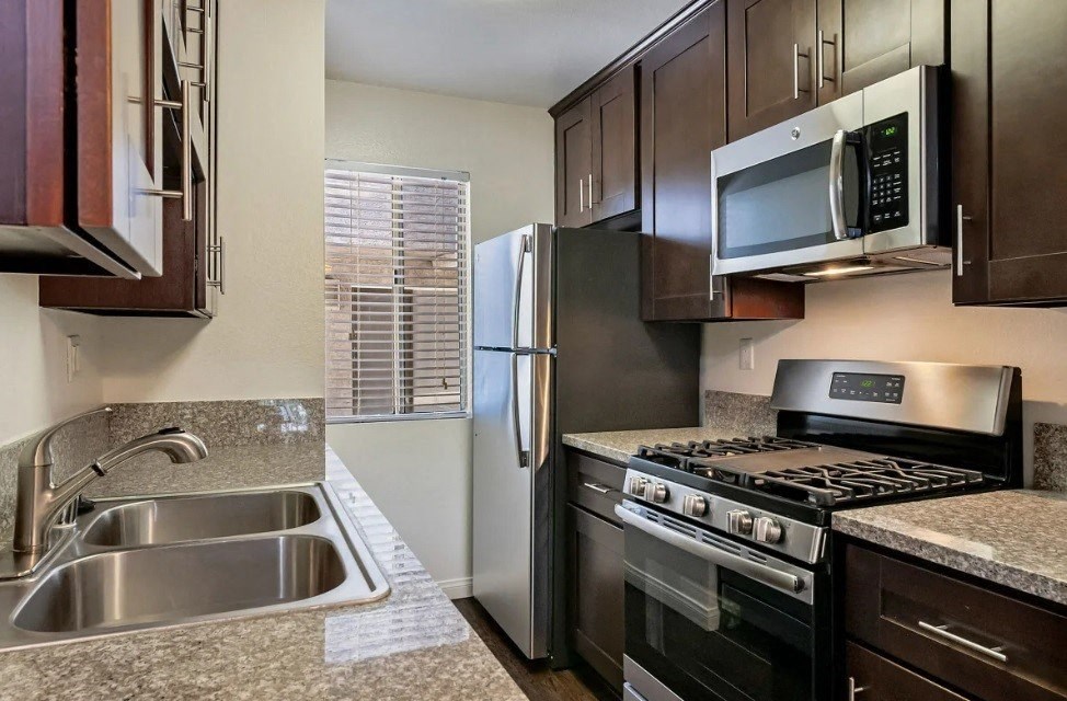 a kitchen with stainless steel appliances and granite counter tops