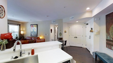 a kitchen and living room with a counter and a sink