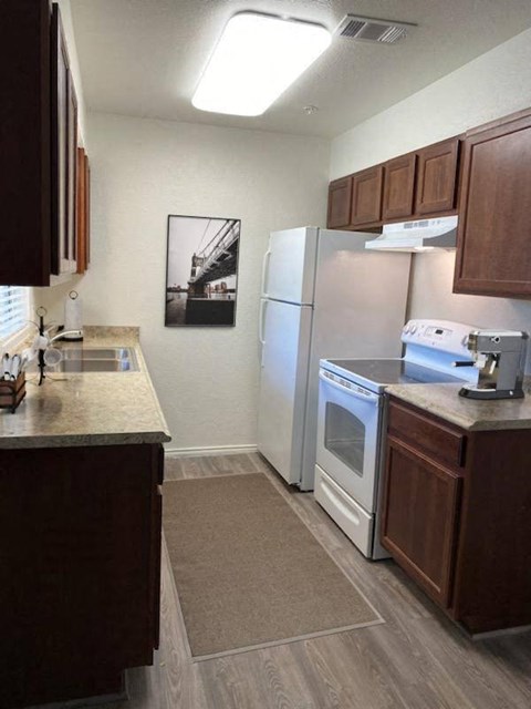 a kitchen with a stove and a refrigerator