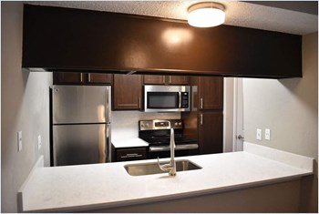 Hidden Oaks Apartment Homes kitchen area with appliances - Photo Gallery 11