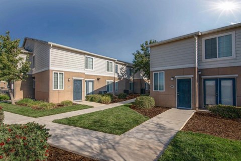 A sunny day at a residential area with houses and green lawns.