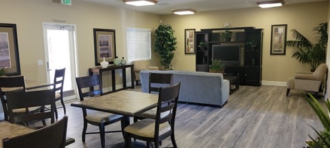 a living room with a table and chairs and a couch