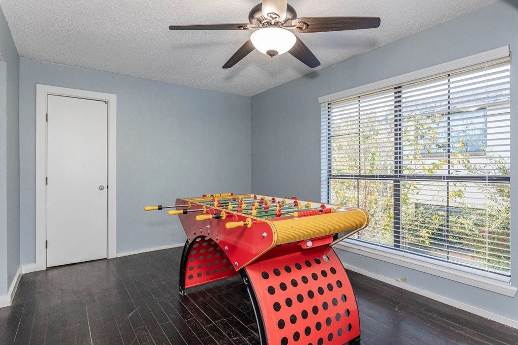 A room with a red chair and a yellow xylophone.