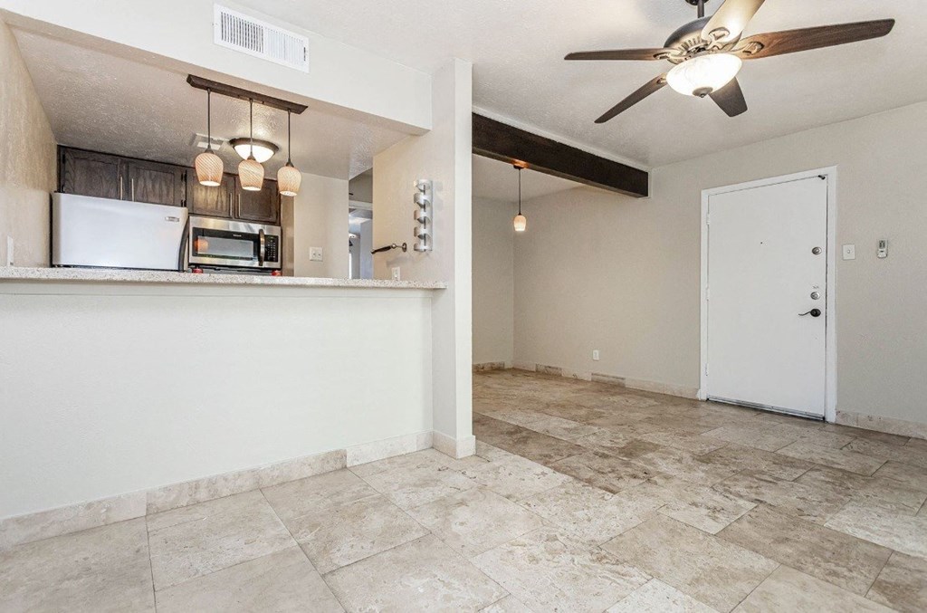 A kitchen area with a refrigerator, microwave, and oven.