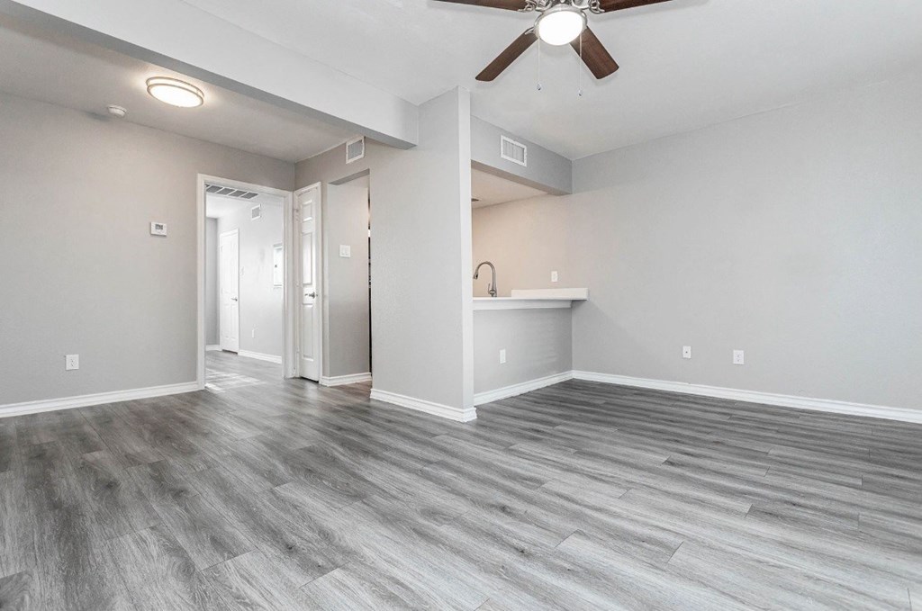 A room with a ceiling fan and light fixture.