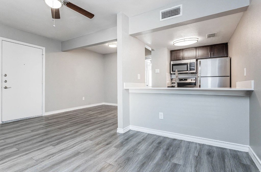 A kitchen area with a refrigerator, microwave, and oven.