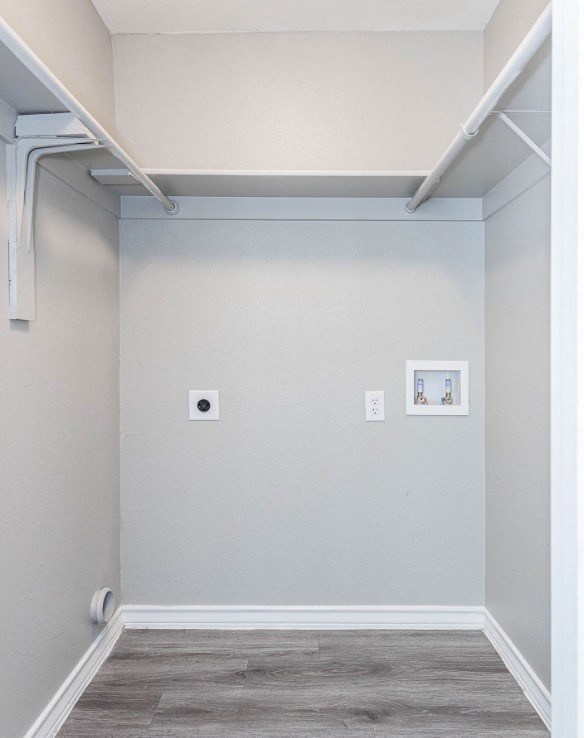 A small room with a white door and a white wall.