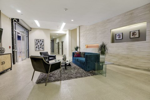 a living room with a couch and chairs and a glass table