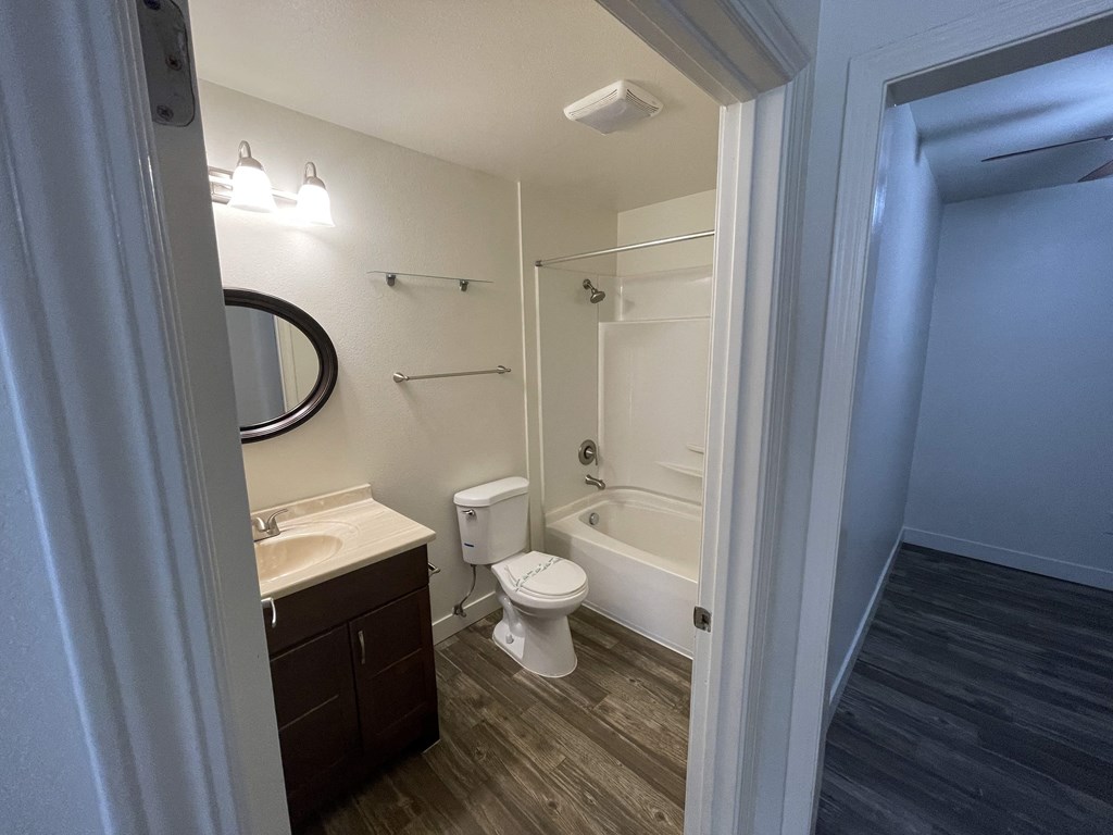 a bathroom with a toilet sink and bathtub in a 555 waverly unit