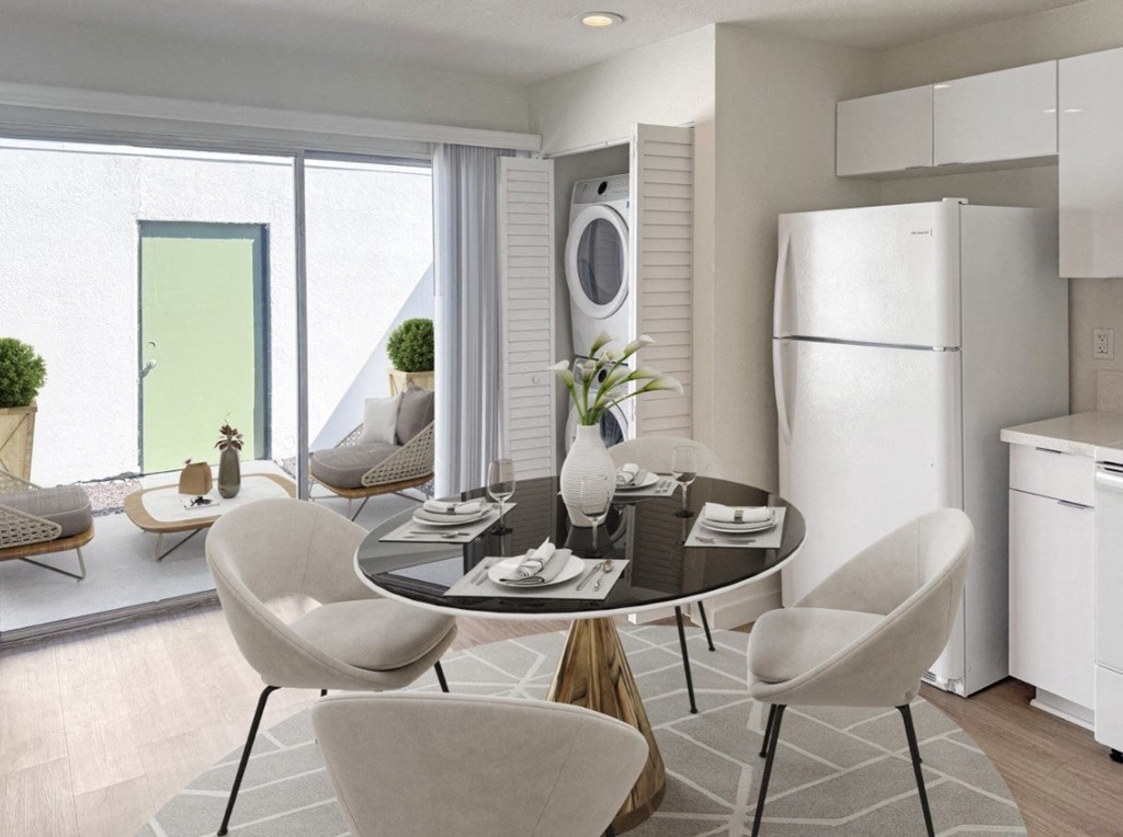 A modern dining room with a round table and chairs.