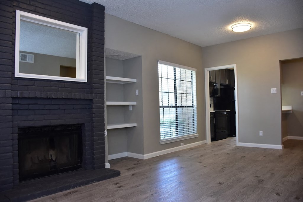 Oakwood Creek Apartments living area with fireplace and shelving