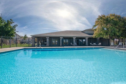 A large swimming pool in front of a building.