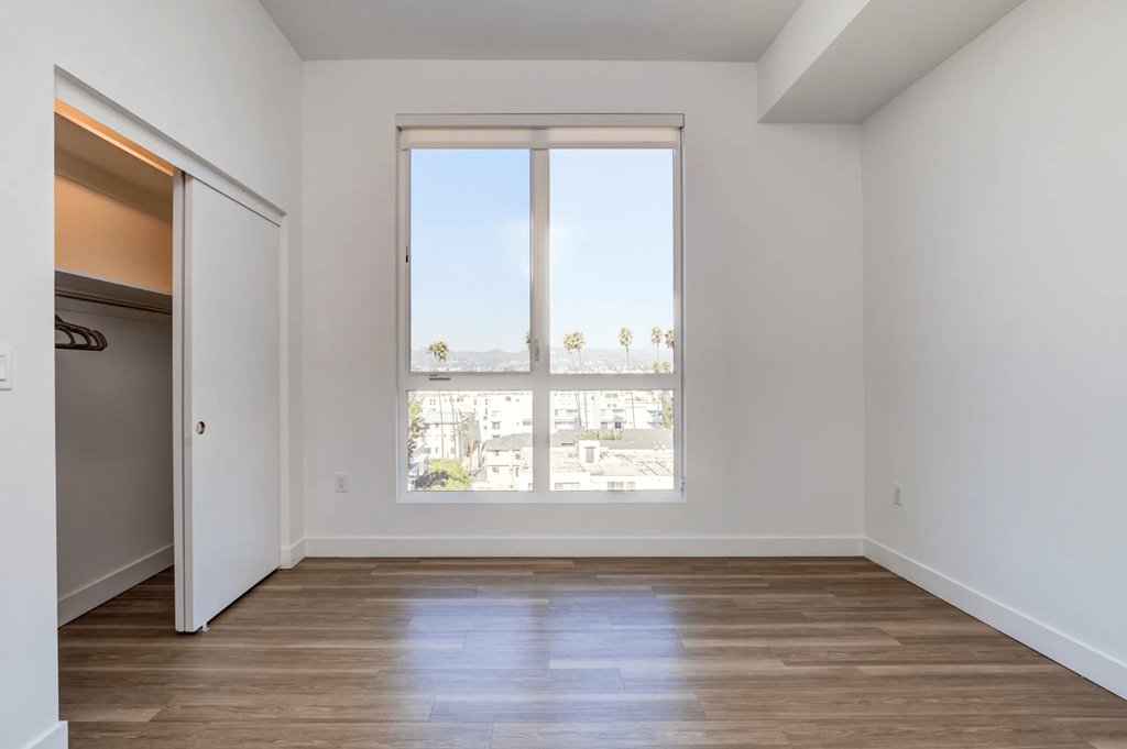 Maya Apartments bedroom with large window