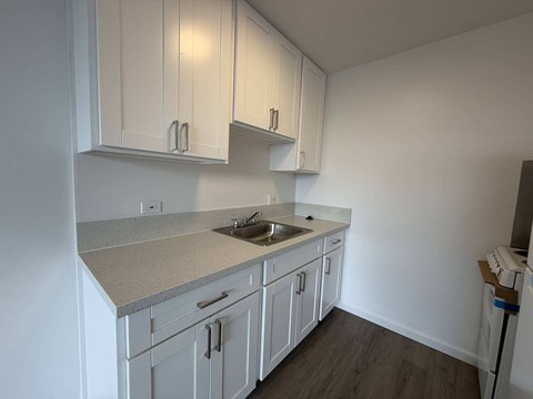 McCully Circle unit 303 kitchen with white cabinets.