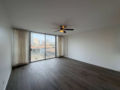 McCully Circle unit 303 living room with a ceiling fan and sliding glass doors.