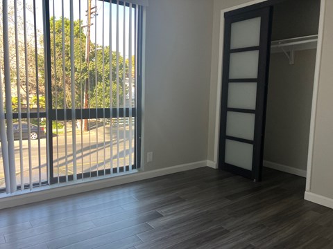 a living room with a large window and a ladder in the corner