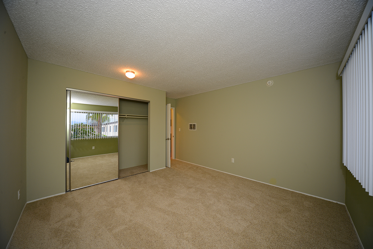 Ocean View Townhomes unfurnished bedroom with a mirror closet
