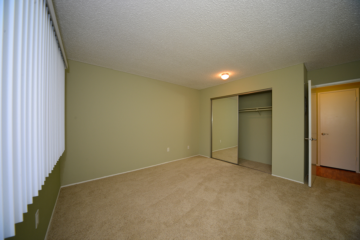 Ocean View Townhomes unfurnished bedroom with a mirror closet