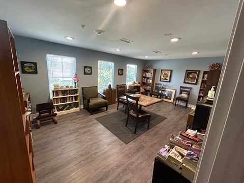 a living room filled with furniture and a book shelf