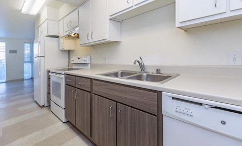 a kitchen with white appliances and a sink
