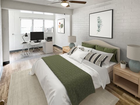 a bedroom with a bed and a desk with a computer