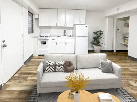 a living room with a couch and a kitchen
