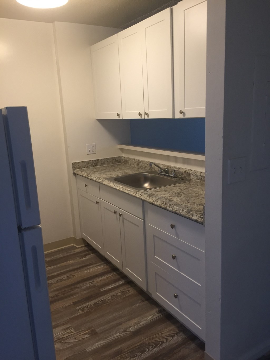 Cambridge Park Apartments and Cluster Park Apartments kitchen area with sink, cabinets, and counters