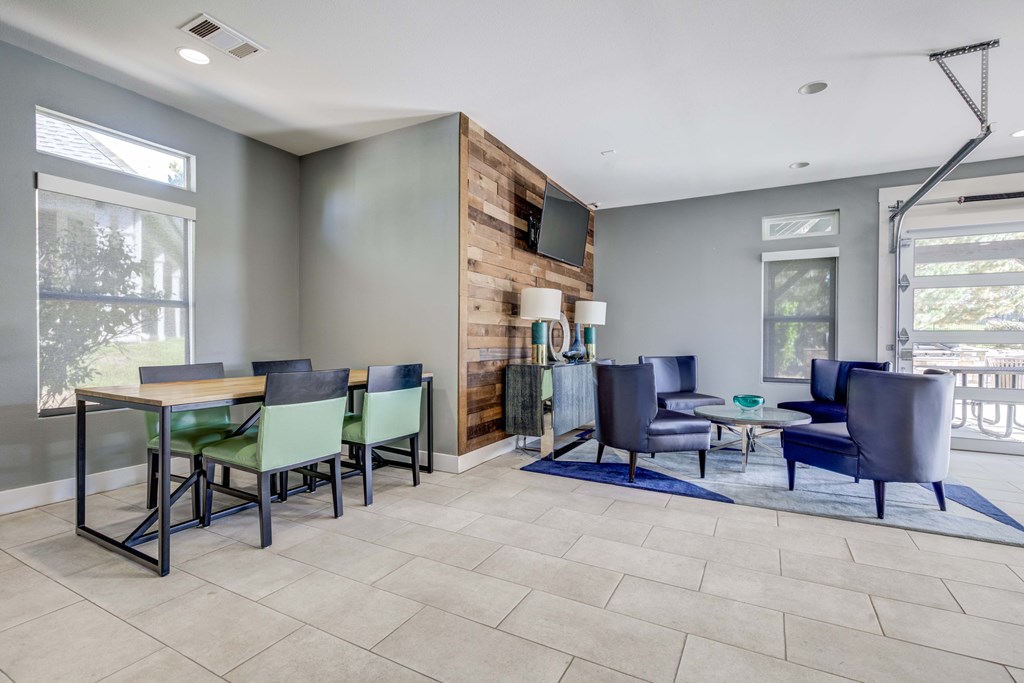 A modern living room with a dining table and chairs.