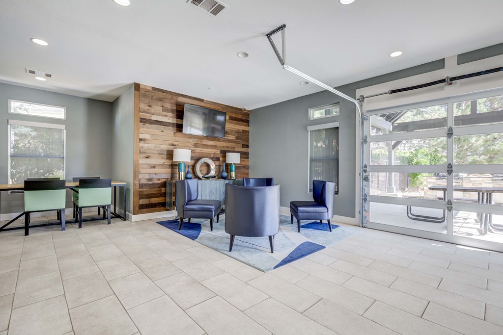 A modern living room with a wooden accent wall and grey furniture.