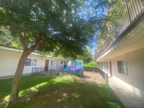 a playground in a yard next to a building