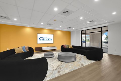 A modern office space with a large sign that reads "Cirrus" on the wall.