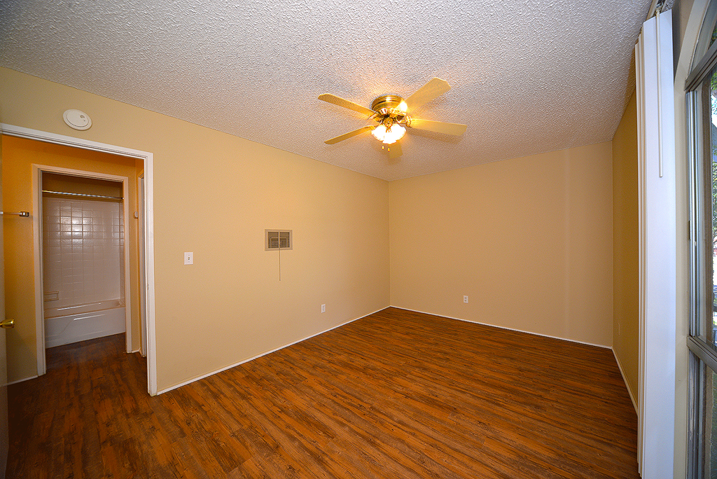 Ponderosa Apartments unfurnished bedroom with ceiling fan