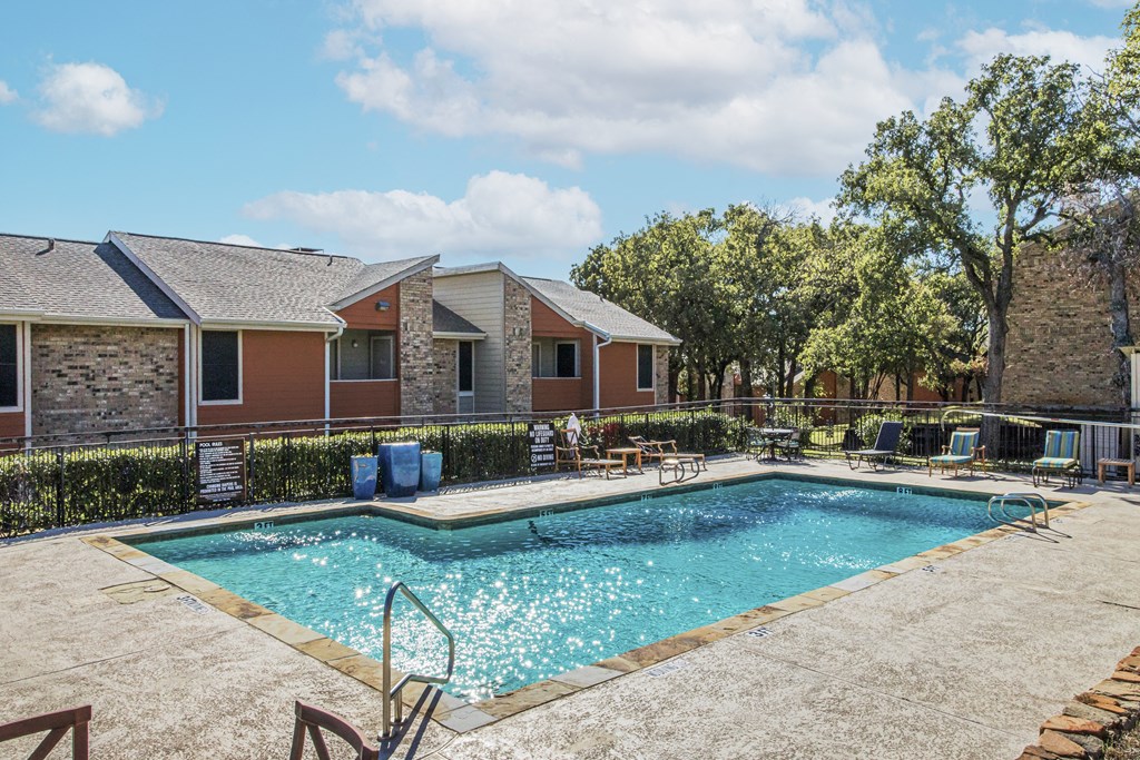 our apartments have a swimming pool and a patio with chairs