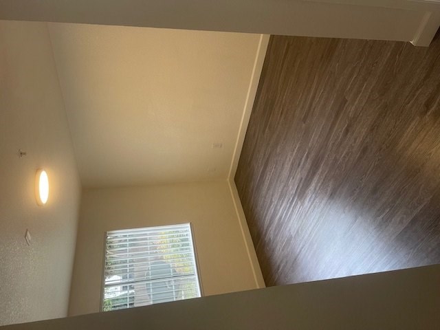A room with a window and a wooden ceiling.